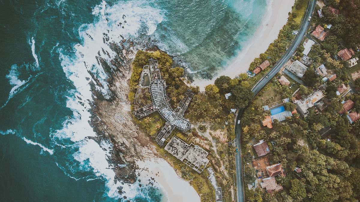 nature aerial photography of houses and buildings near body of water aerial view
